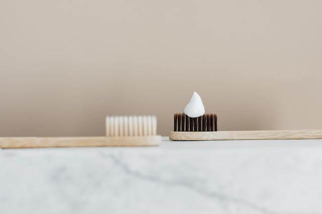 two toothbrush with some toothpaste on it